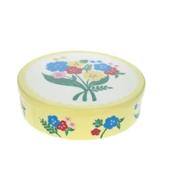 Boîte ronde en métal jaune à fleurs